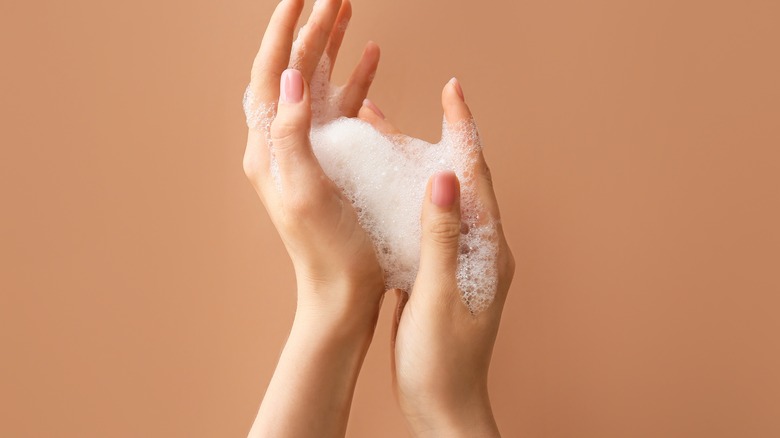 hands with foam between