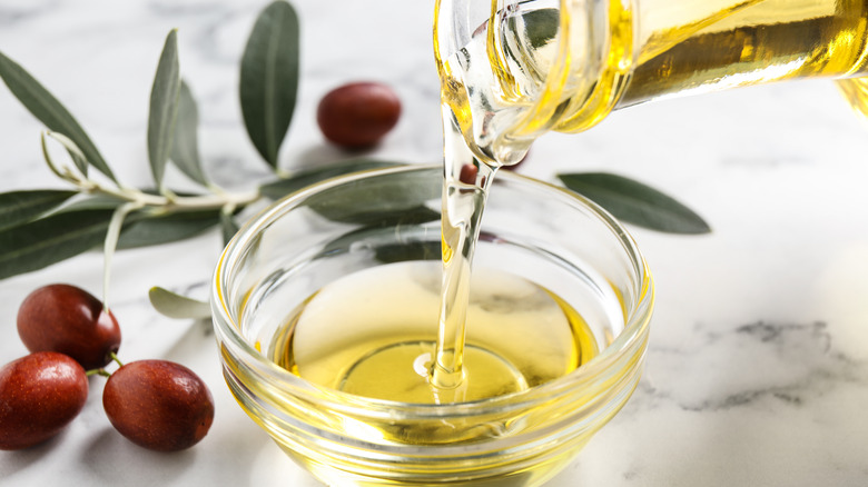 Jojoba oil being poured into bowl