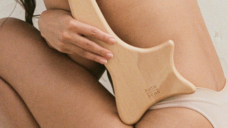 using large gua sha on body