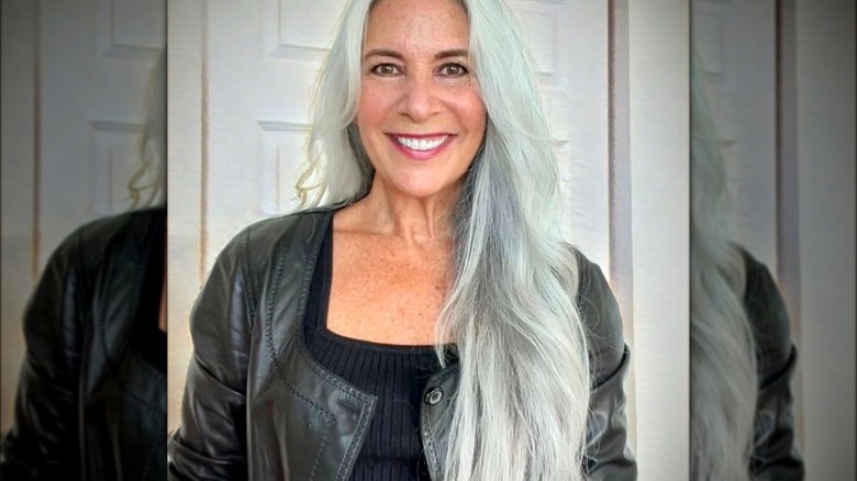 Woman with long silver hair wearing black