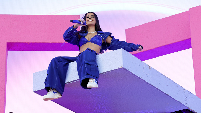 Becky G sitting on platform