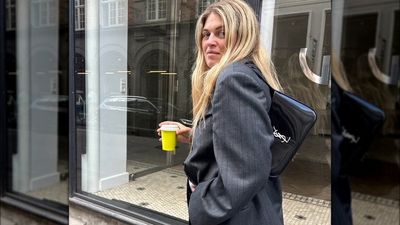 Woman with blond hair in gray blazer