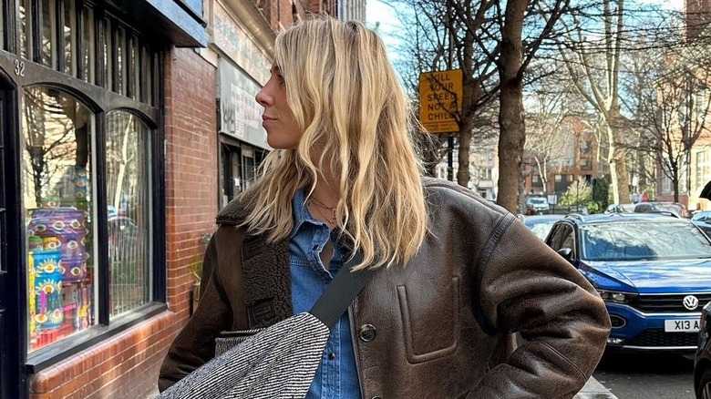 Woman in brown leather jacket and blond hair