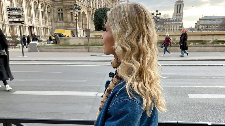 Person with blond hair wearing denim