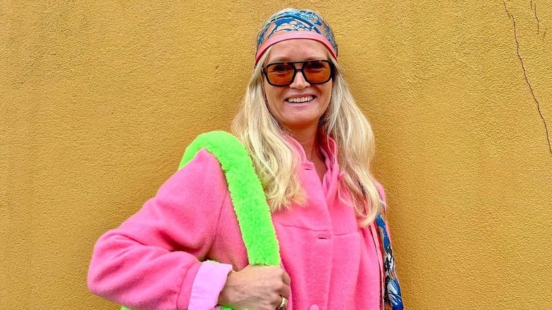 Woman in pink jacket with blond hair