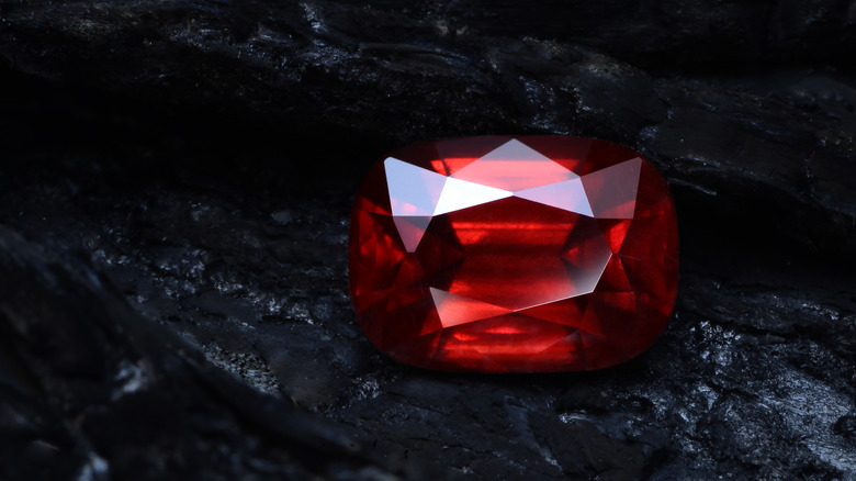 Polished garnet gemstone, black background