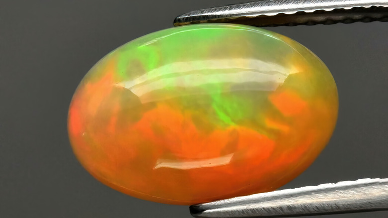 fire opal in tongs