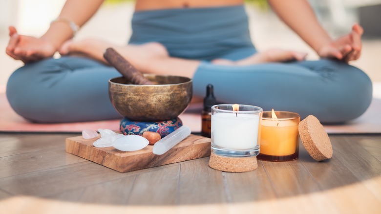 Person sitting, meditating with crystals