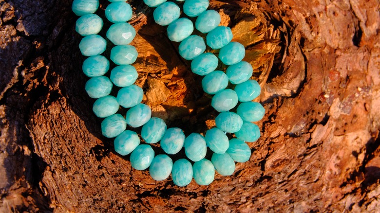 amazonite beads on brown background