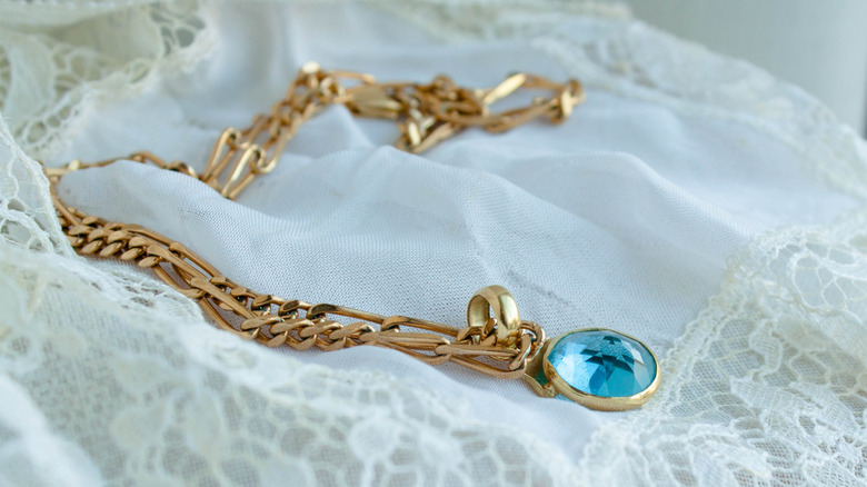 aquamarine necklace on white cloth