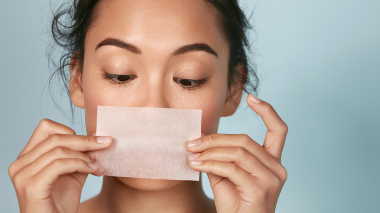 woman using blotting paper