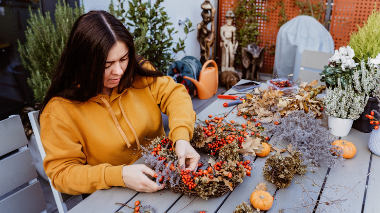 A woman making a fall wreath