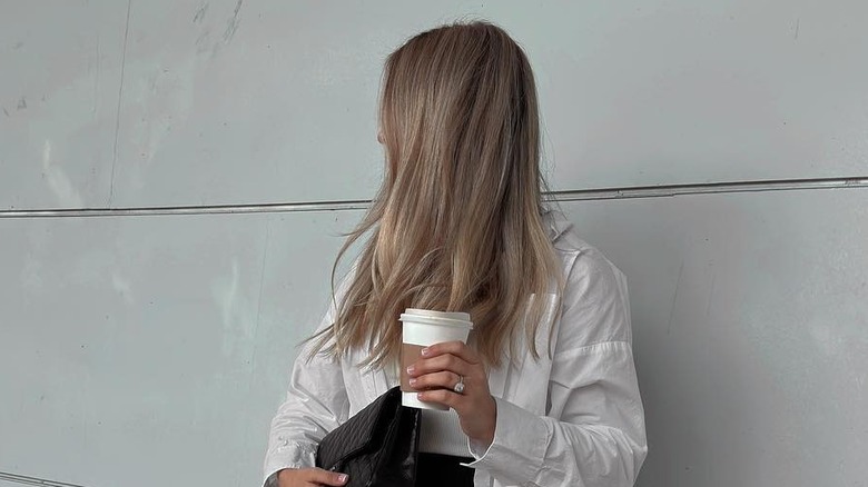 blond woman holding coffee