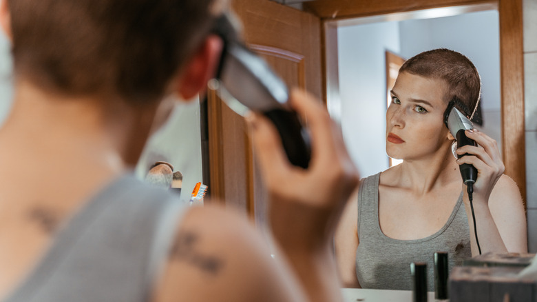 woman applying oil to scalp