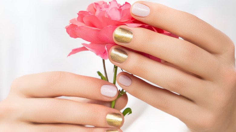 Gold nails holding flower