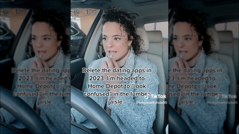 Woman applying lip gloss in Home Depot parking lot