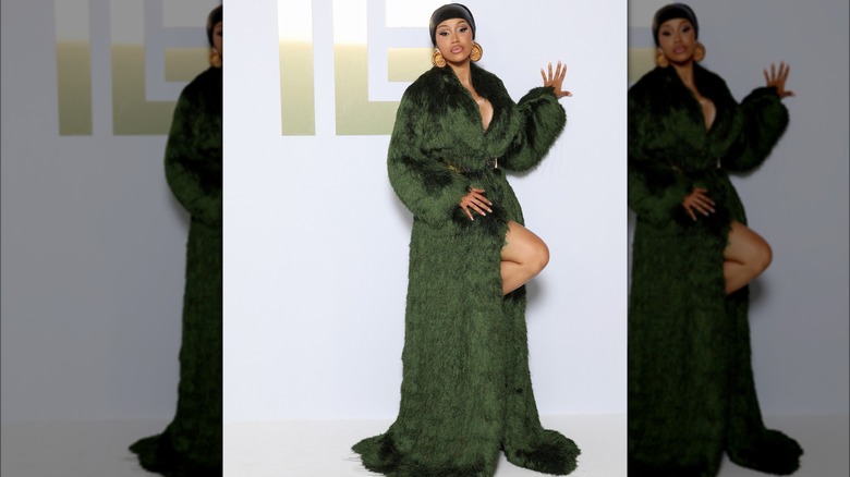 Cardi B at Paris Fashion Week in a green fur coat.