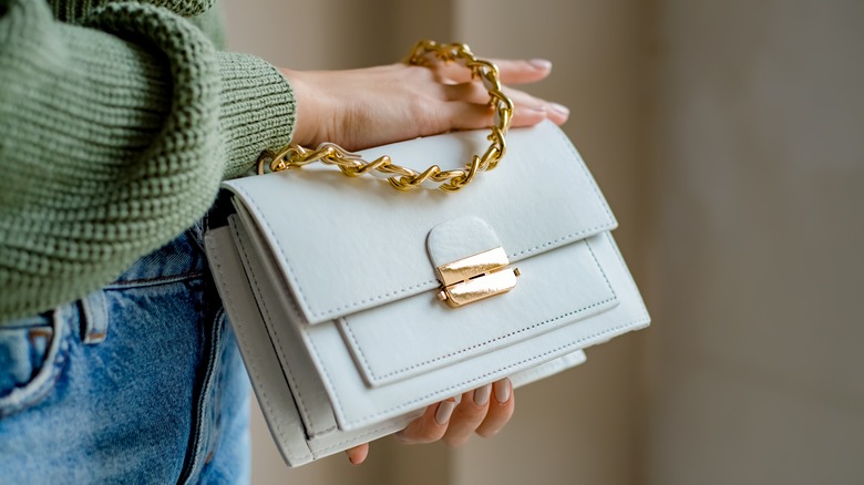 Woman holding luxury designer handbag