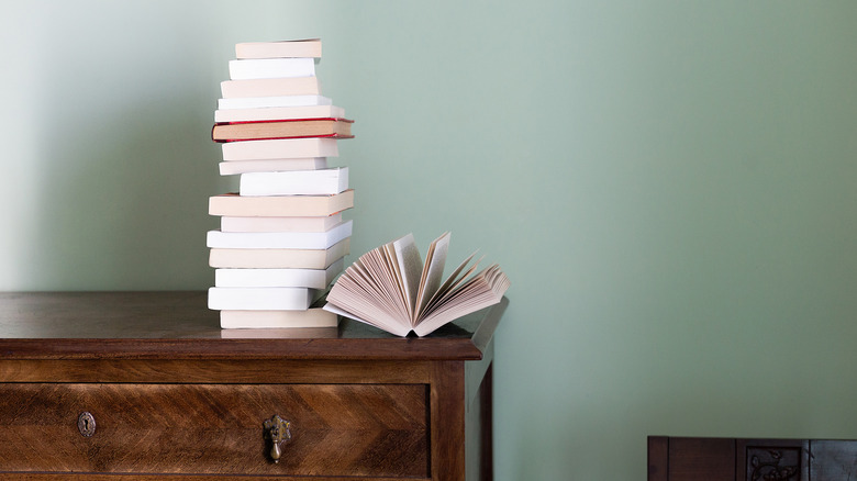 stack of books on a dresser