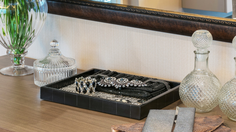 close up of jewelry tray on dresser