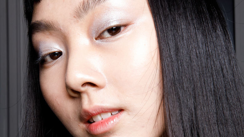 Asian woman wearing silver eyeshadow