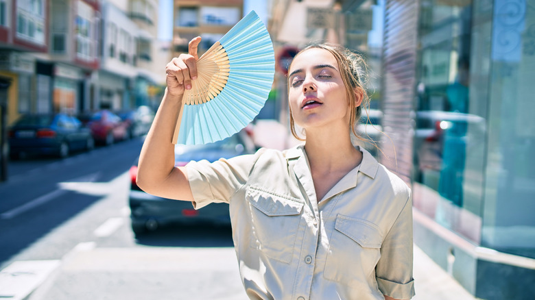 Woman fanning herself in the heat