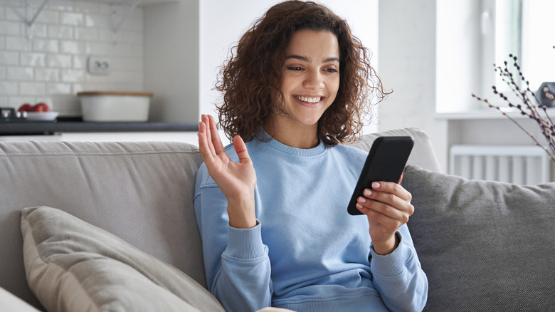 Woman happy phone couch