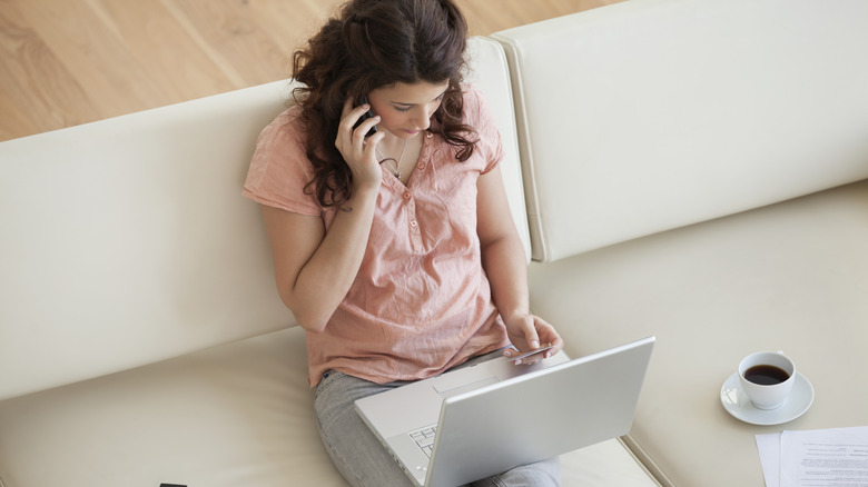 Woman on phone and laptop