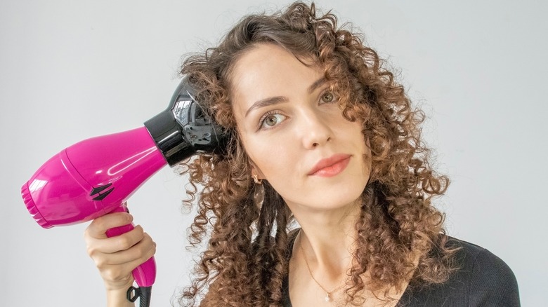 curly-haired woman diffusing hair