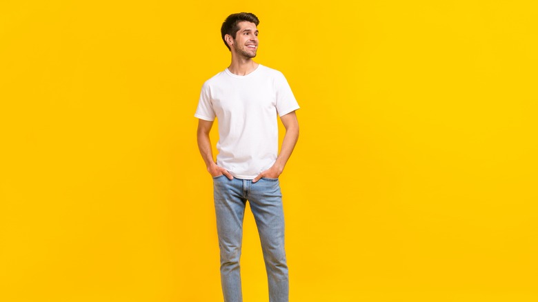 Man wearing soft jeans with yellow background