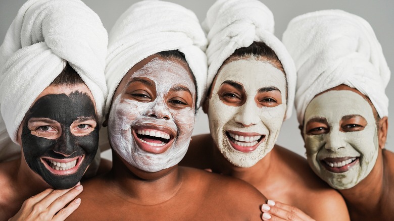 Four women wearing different face masks