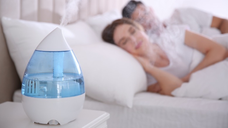 Humidifier next to sleeping couple