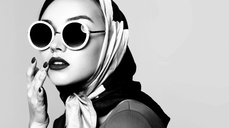 woman wearing headscarf and round sunglasses