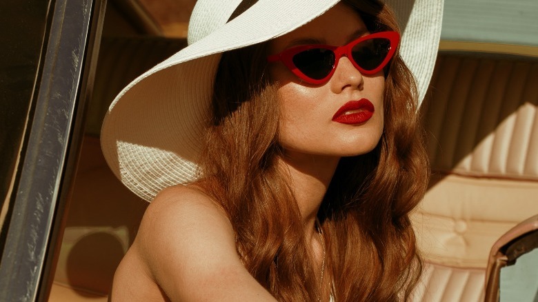 Woman in red cat-eye sunglasses