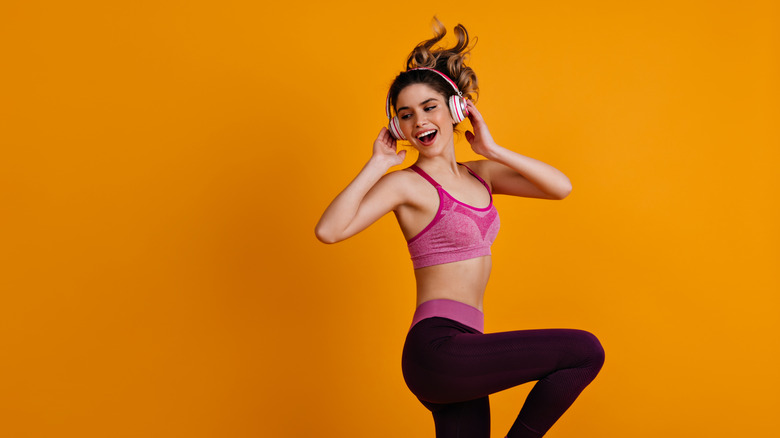 Happy woman dancing with headphones