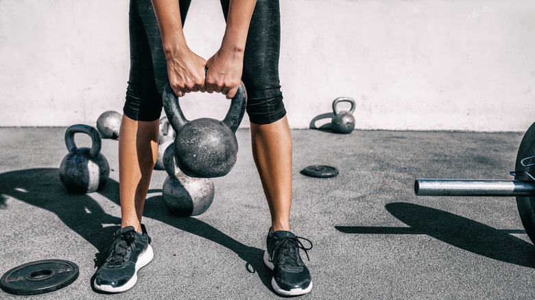 Athletic woman lifting a kettlebell