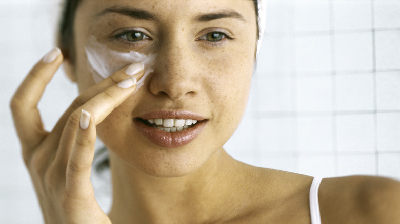 Woman with lots of eye cream