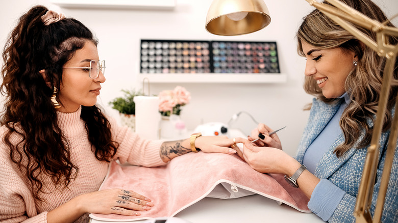 Woman getting manicure