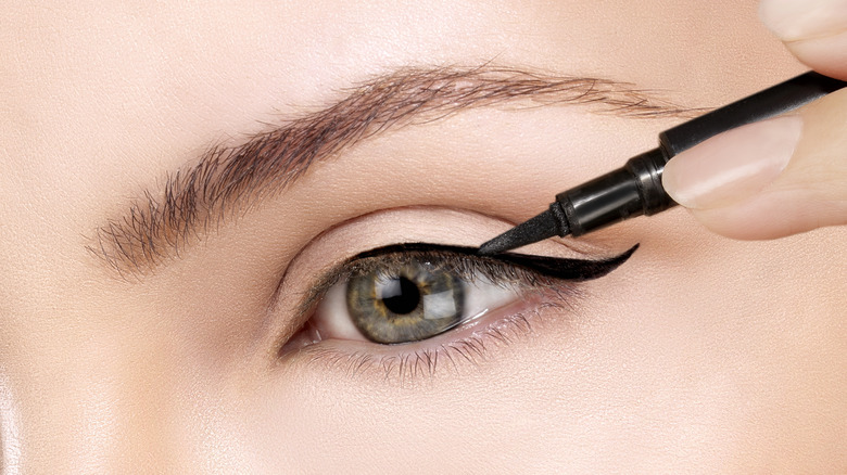 Applying eyeliner to hazel eyes