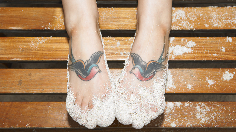 Feet with bird tattoos