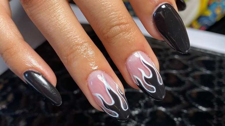 black flame manicure outlined in white