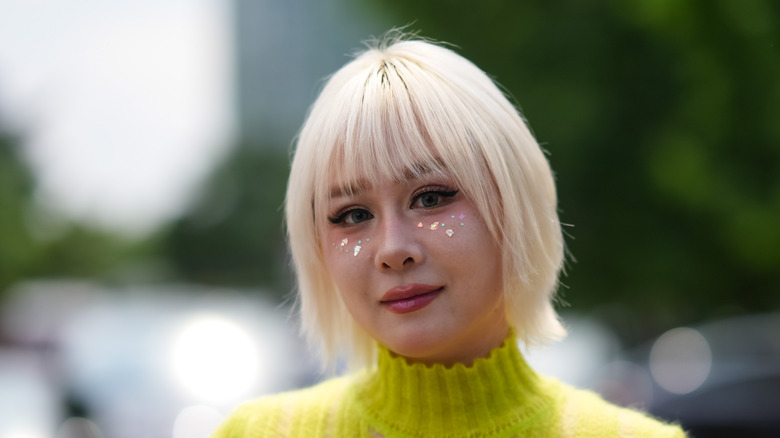 Woman with blond bob and bangs