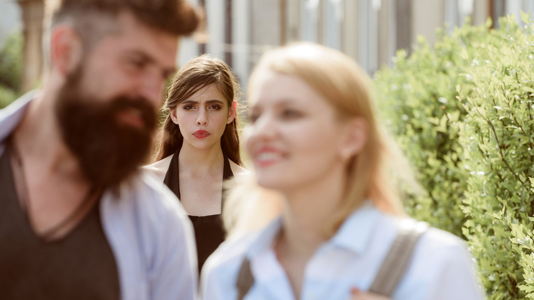 Jealous woman watching a couple