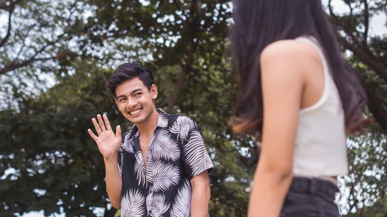 Nervous guy waving at his crush