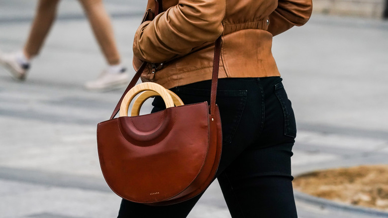 Woman with red bag, wooden handles