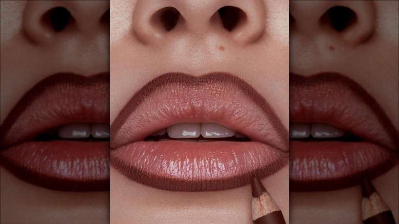 Woman lining her lips
