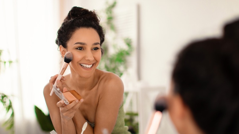 Woman applying makeup