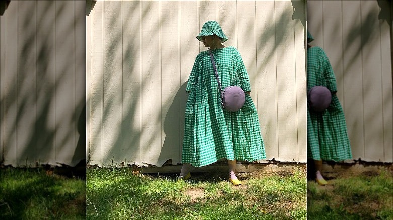 person wearing green checkered bucket hat outfit