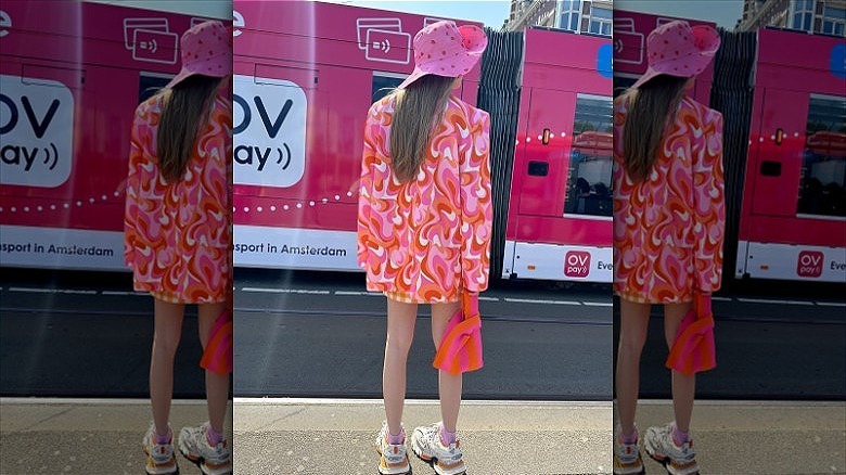 woman wearing pink strawberry bucket hat