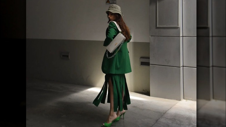 woman wearing monochrome green bucket hat outfit